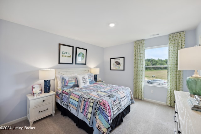 bedroom featuring light carpet