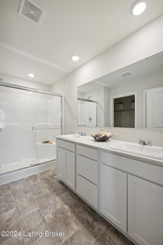 bathroom with an enclosed shower and vanity