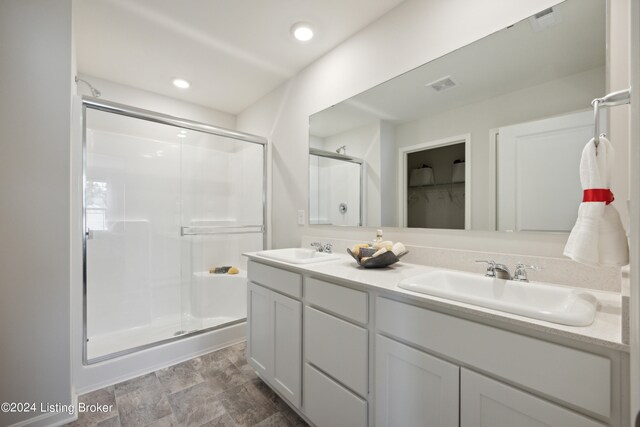 bathroom with vanity and an enclosed shower