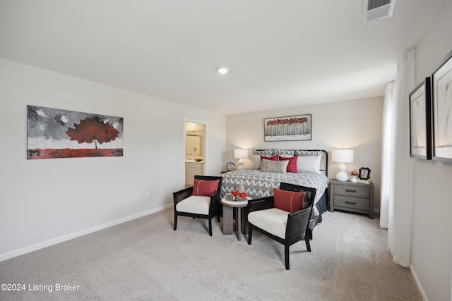 bedroom featuring light carpet and ensuite bathroom