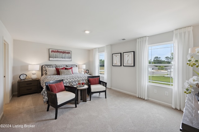 bedroom featuring light carpet