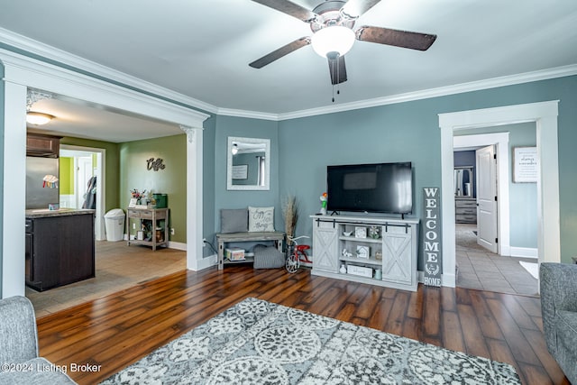 living room with crown molding, hardwood / wood-style floors, and ceiling fan