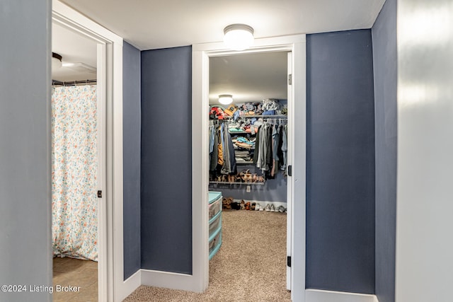 hall with light colored carpet