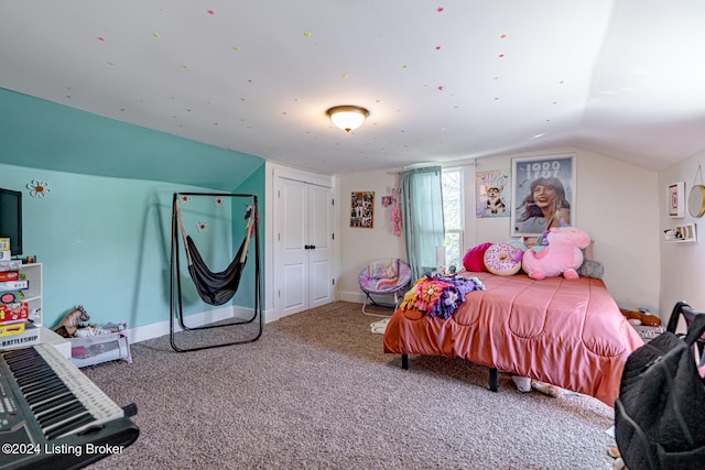 bedroom with vaulted ceiling and carpet flooring