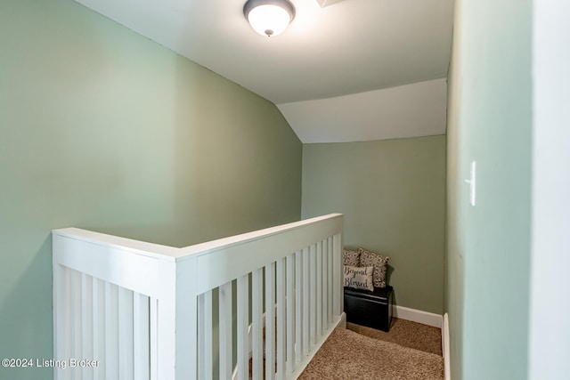 corridor with light carpet and lofted ceiling