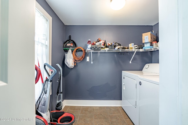 laundry room featuring a healthy amount of sunlight and washer and dryer