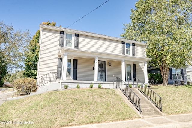 view of front of house featuring a front lawn and covered porch