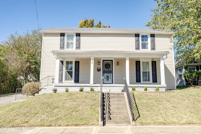 view of front facade with a front lawn and covered porch