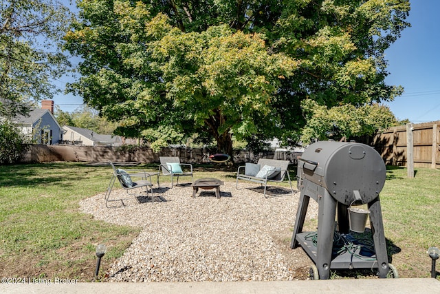 view of yard featuring an outdoor fire pit