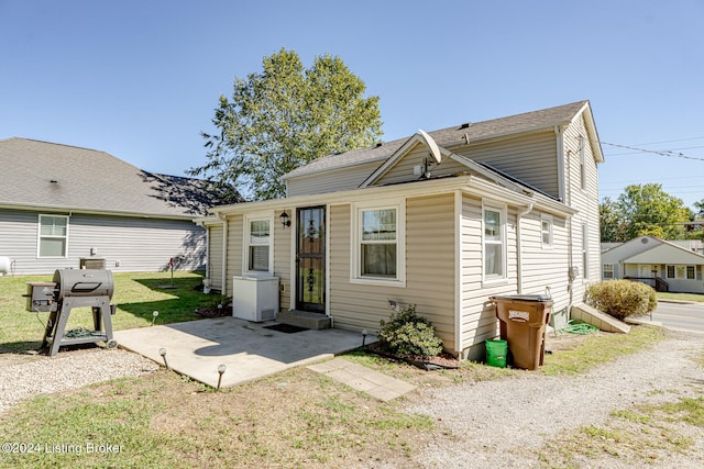 bungalow-style home with a front lawn and a patio area