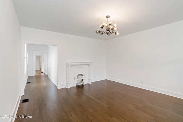 interior space with a fireplace, dark wood-type flooring, and an inviting chandelier