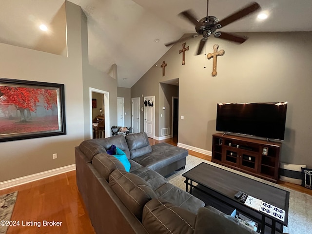 living room with hardwood / wood-style flooring, high vaulted ceiling, and ceiling fan