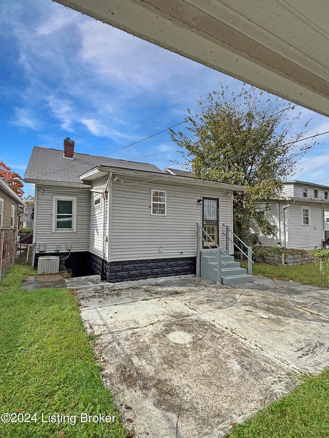 rear view of property featuring central AC unit