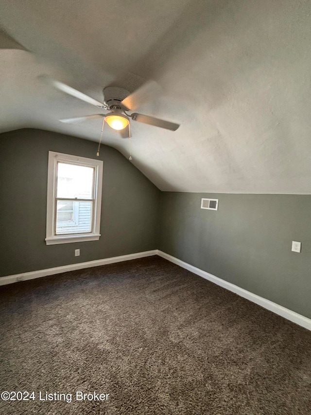 bonus room with lofted ceiling, carpet flooring, a textured ceiling, and ceiling fan