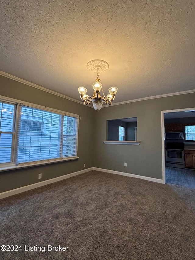 carpeted spare room with ornamental molding, a textured ceiling, and a healthy amount of sunlight