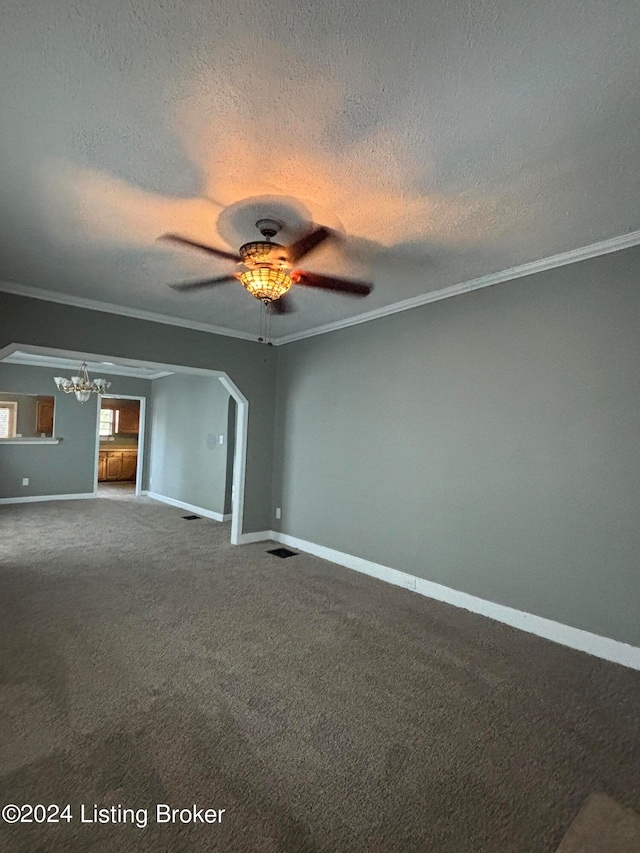 carpeted spare room with crown molding, a textured ceiling, and ceiling fan