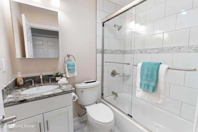 full bathroom featuring vanity, toilet, and bath / shower combo with glass door