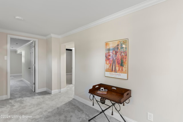 hallway featuring light carpet and crown molding