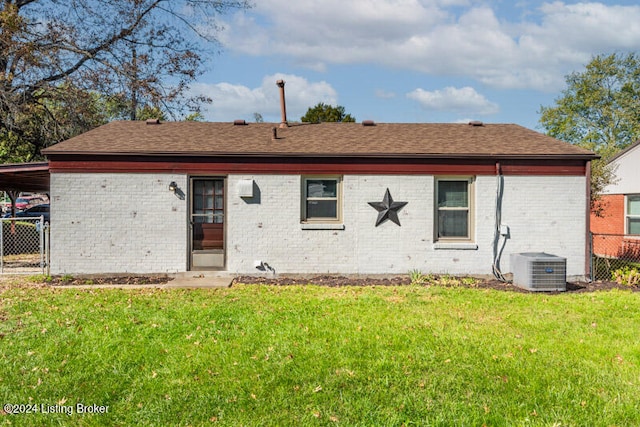 rear view of property featuring a yard