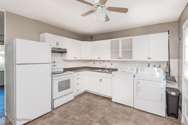 kitchen featuring washing machine and dryer, a wealth of natural light, white appliances, and sink