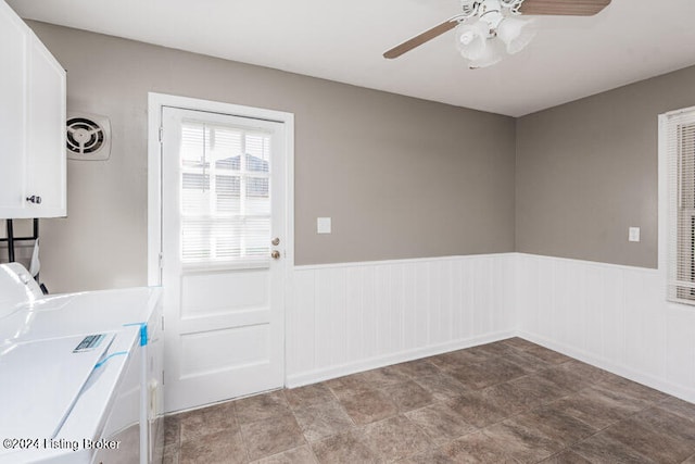 laundry room with washing machine and clothes dryer, cabinets, and ceiling fan