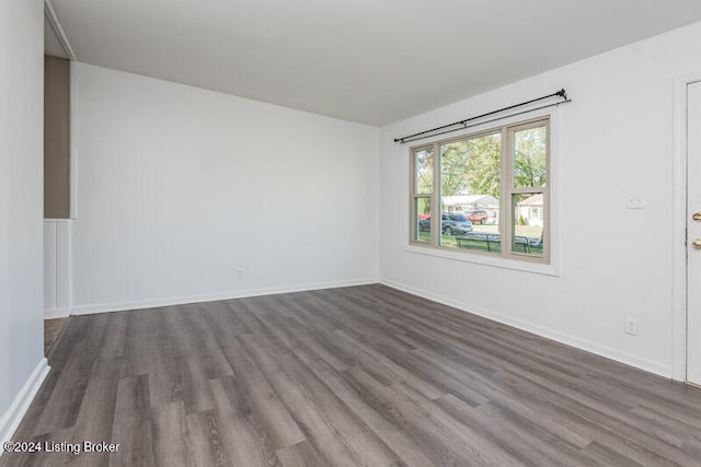 unfurnished room featuring dark hardwood / wood-style flooring