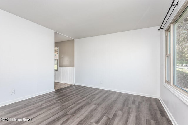 spare room with plenty of natural light and hardwood / wood-style floors