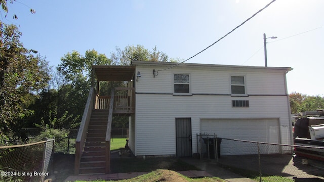 rear view of property featuring a garage