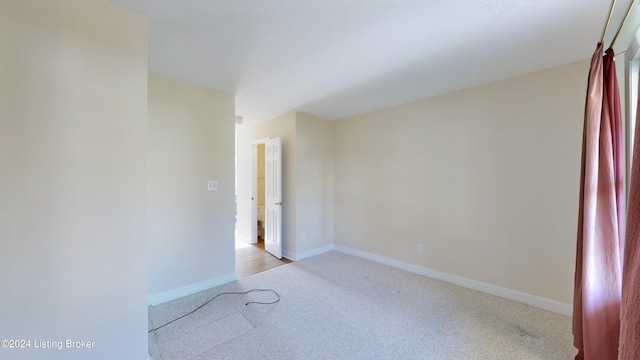 spare room with light colored carpet