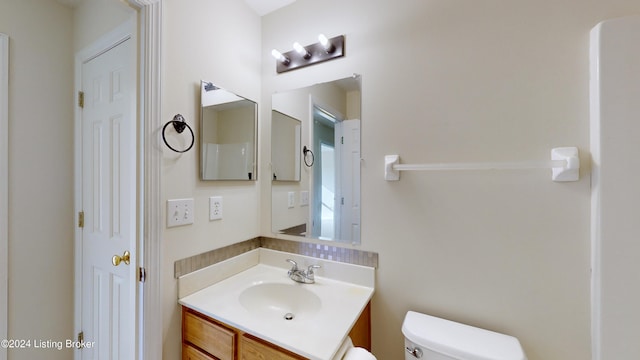 bathroom featuring vanity and toilet