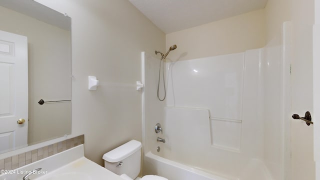 full bathroom with sink, shower / tub combination, and toilet