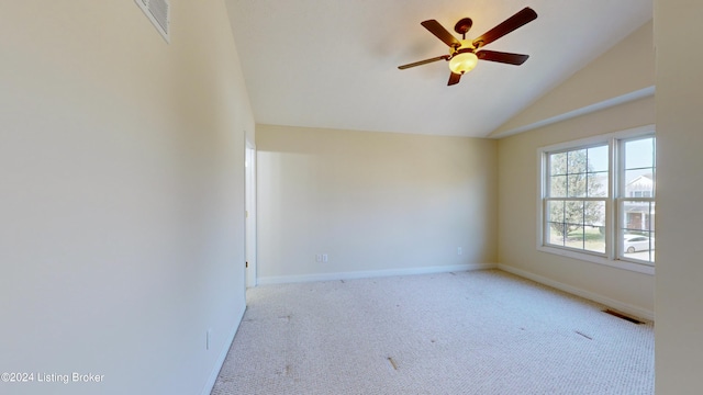 empty room with ceiling fan, high vaulted ceiling, and light carpet