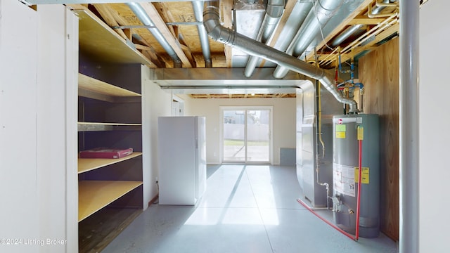 interior space with gas water heater and white refrigerator