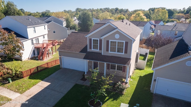 view of front of property with a front yard and a garage