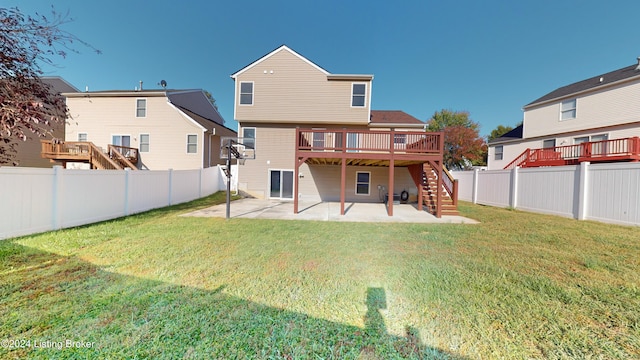 back of house featuring a wooden deck, a patio, and a lawn