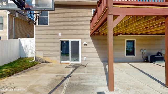 back of property with central AC unit and a patio area