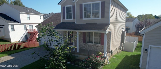 view of front of house featuring a garage and a front lawn