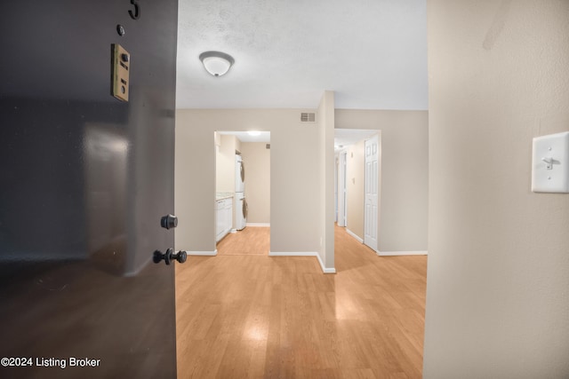 hallway with light wood-type flooring