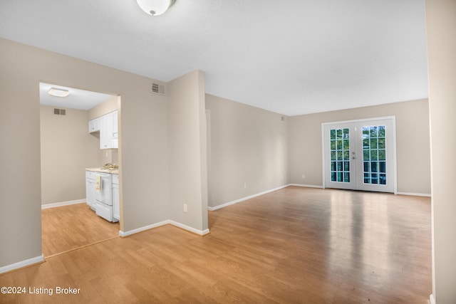 empty room with french doors and light hardwood / wood-style floors