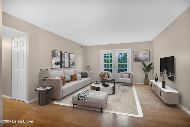 living room featuring french doors and light hardwood / wood-style flooring