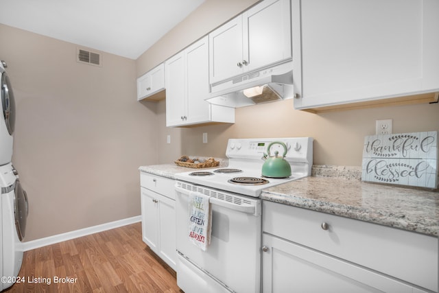 kitchen with white cabinets, stacked washer and clothes dryer, light hardwood / wood-style flooring, white electric range, and light stone countertops