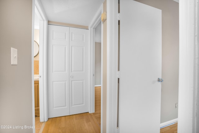 corridor with light hardwood / wood-style floors