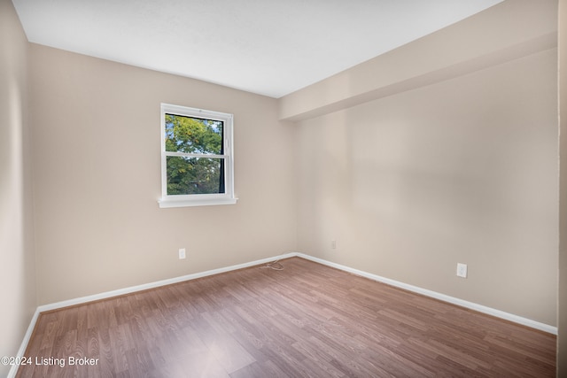 empty room with hardwood / wood-style floors