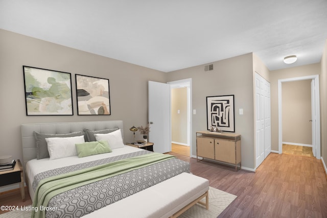 bedroom featuring a closet and wood-type flooring