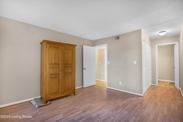 unfurnished room with light wood-type flooring