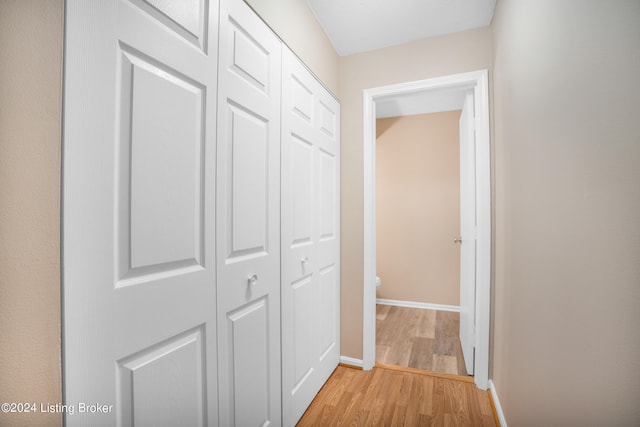 corridor with light hardwood / wood-style flooring