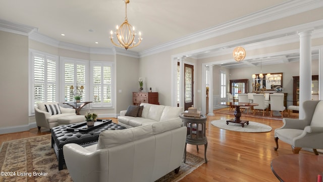 living room featuring ornamental molding, decorative columns, and light wood-type flooring