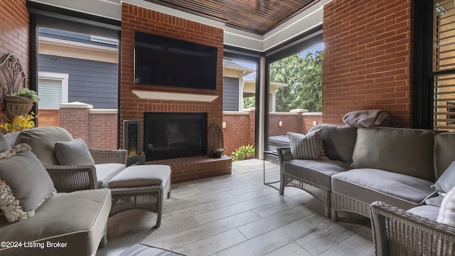 view of patio with an outdoor living space with a fireplace