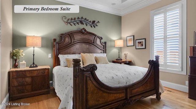 bedroom with ornamental molding, light hardwood / wood-style flooring, and multiple windows