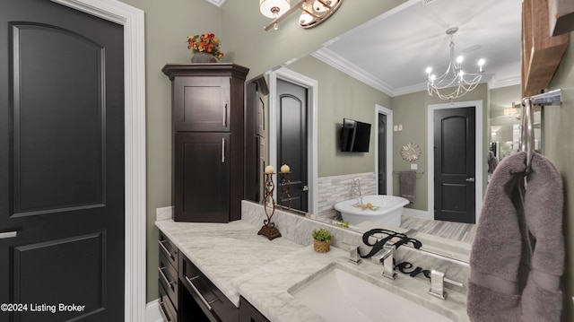 bathroom with crown molding, a chandelier, and vanity